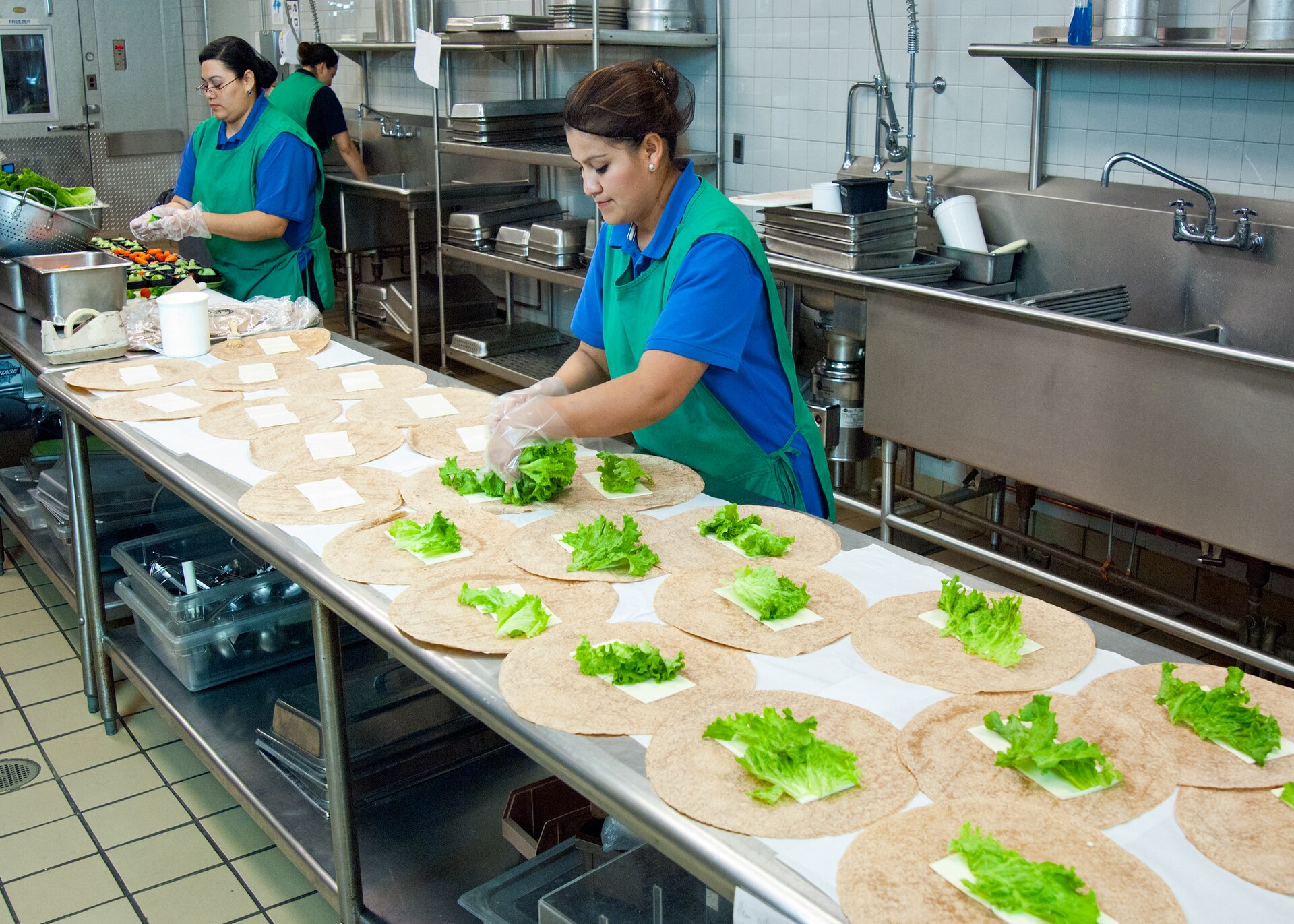 Real people preparing food in a kitchen class
