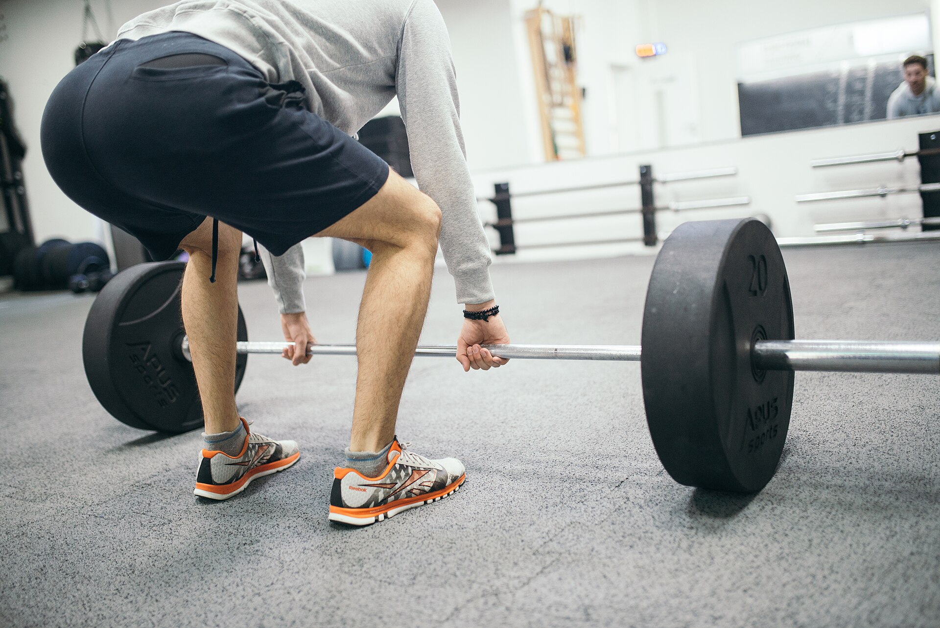 Real person doing a deadlift in a gym